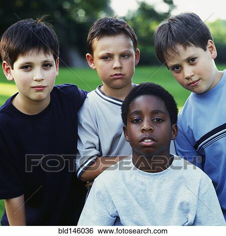 Serious boys standing together outdoors View Large Photo Image Stock Photograph - Serious boys standing together outdoors. Fotosearch