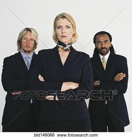 Stock Photograph - Serious business people standing together. Fotosearch