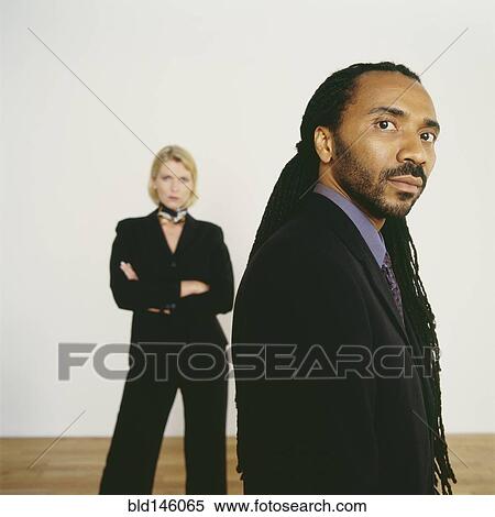 Serious business people standing together View Large Photo Image Stock Photography - Serious business people standing together. Fotosearch