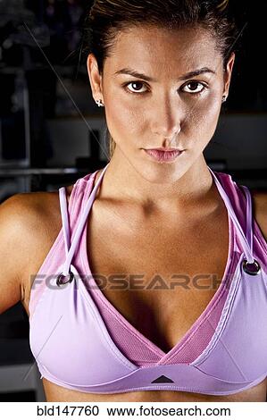 Stock Image - Serious Hispanic woman in sportswear. Fotosearch