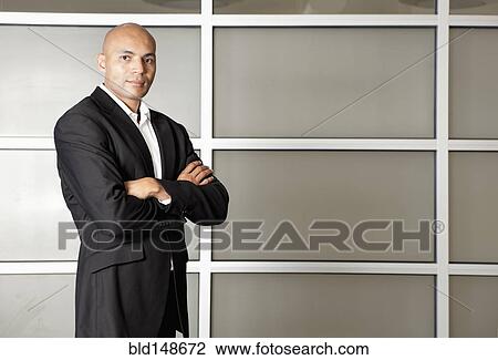 Serious mixed race businessman in office with arms crossed View Large Photo Image Stock Image - Serious mixed race businessman in office with arms crossed. Fotosearch