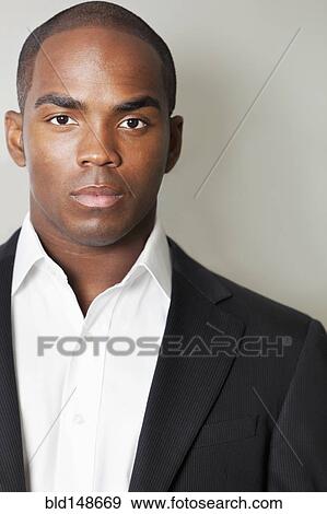 Stock Photo - Serious mixed race businessman. Fotosearch