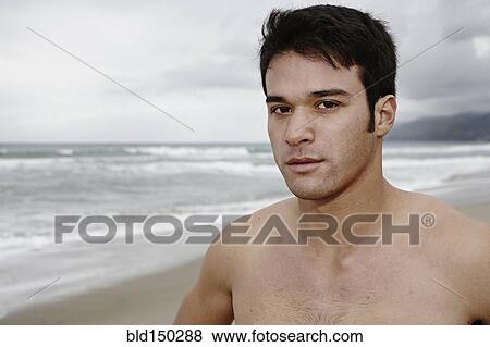 Serious young man on beach View Large Photo Image Stock Photo - Serious young man on beach. Fotosearch