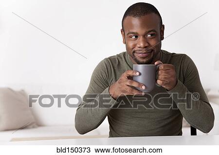 Smiling Black man drinking coffee View Large Photo Image Stock Image - Smiling Black man drinking coffee. Fotosearch