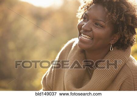 Smiling Black woman outdoors View Large Photo Image Stock Photo - Smiling Black woman outdoors. Fotosearch