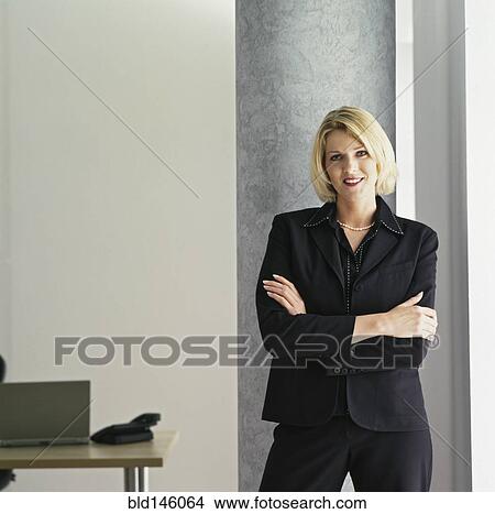 Picture - Smiling businesswoman with arms crossed. Fotosearch