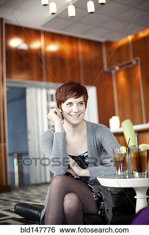 Smiling Caucasian woman in restaurant View Large Photo Image Stock Photograph - Smiling Caucasian woman in restaurant. Fotosearch