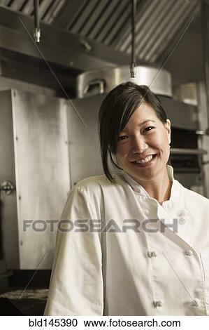 Smiling Chinese chef standing in commercial kitchen View Large Photo Image Stock Image - Smiling Chinese chef standing in commercial kitchen. Fotosearch