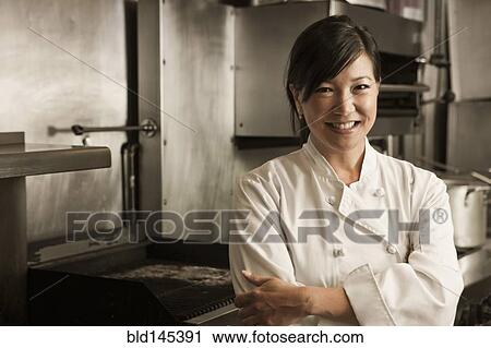 Smiling Chinese chef standing in commercial kitchen View Large Photo Image Stock Image - Smiling Chinese chef standing in commercial kitchen. Fotosearch