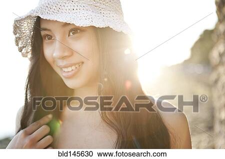 Stock Image - Smiling Chinese woman in hat. Fotosearch