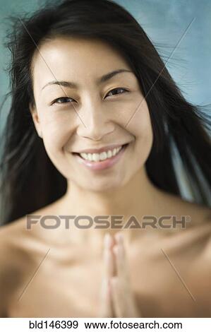 Smiling Chinese woman praying View Large Photo Image Stock Photo - Smiling Chinese woman praying. Fotosearch