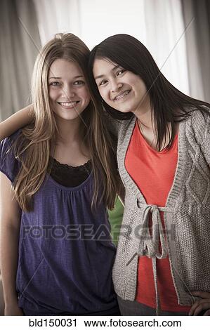 Stock Image - Smiling friends hugging. Fotosearch