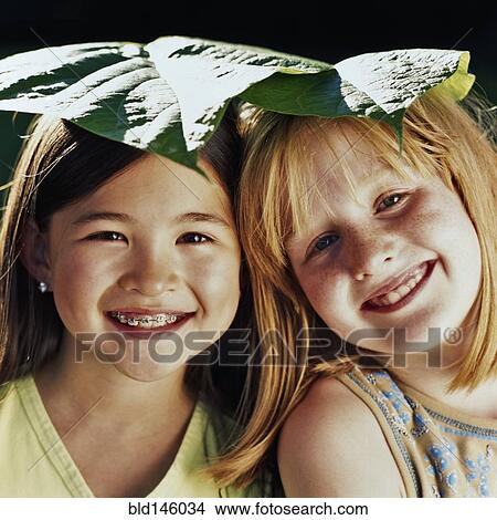 Smiling girls with leaves on their heads View Large Photo Image Picture - Smiling girls with leaves on their heads. Fotosearch