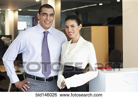 Stock Photograph - Smiling Hispanic business people in office. Fotosearch