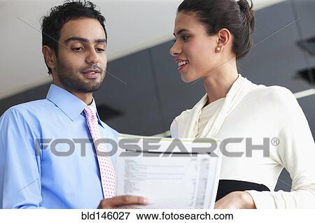 Smiling Hispanic business people working together in office View Large Photo Image Stock Photo - Smiling Hispanic business people working together in office. Fotosearch