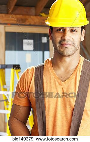 Stock Photo - Smiling Hispanic construction worker. Fotosearch