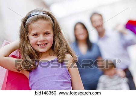 Smiling Hispanic girl carrying shopping bag View Large Photo Image Stock Image - Smiling Hispanic girl carrying shopping bag. Fotosearch