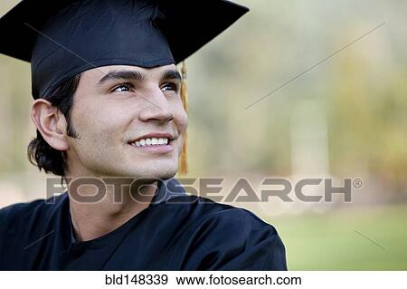 Smiling Hispanic graduate in cap and gown View Large Photo Image Stock Photo - Smiling Hispanic graduate in cap and gown. Fotosearch