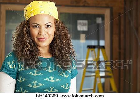 Smiling Hispanic woman on construction site View Large Photo Image Stock Photo - Smiling Hispanic woman on construction site. Fotosearch