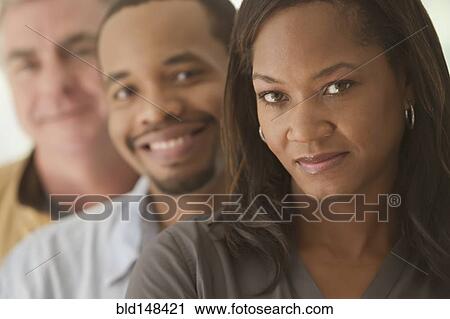 Smiling men and woman standing together View Large Photo Image Stock Image - Smiling men and woman standing together. Fotosearch