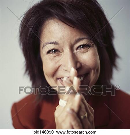 Smiling mixed race businesswoman with hands clasped View Large Photo Image Stock Image - Smiling mixed race businesswoman with hands clasped. Fotosearch