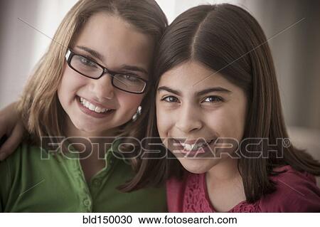 Smiling mixed race friends hugging View Large Photo Image Stock Image - Smiling mixed race friends hugging. Fotosearch