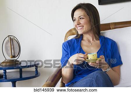 Stock Photo - Smiling woman drinking coffee. Fotosearch