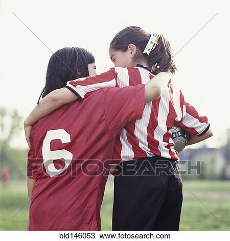 Stock Image - Soccer players hugging. Fotosearch