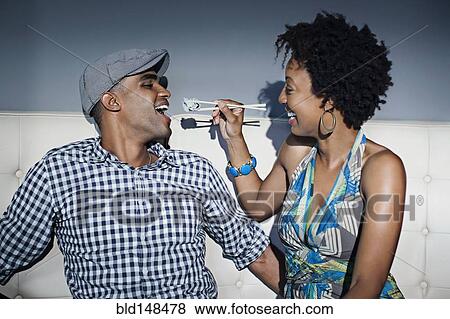 Woman feeding boyfriend sushi with chopsticks View Large Photo Image Stock Photo - Woman feeding boyfriend sushi with chopsticks. Fotosearch