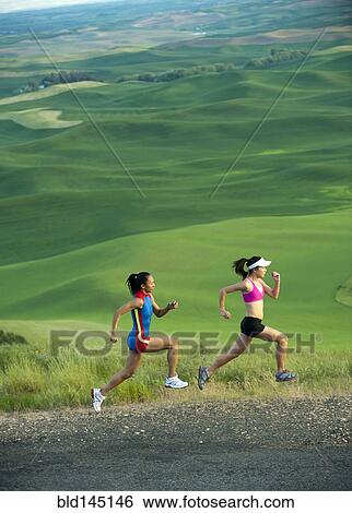 Stock Photograph - Women runners running in countryside. Fotosearch
