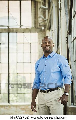 Black businessman smiling in warehouse View Large Photo Image Stock Image - Black businessman smiling in warehouse. Fotosearch