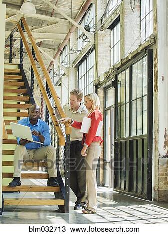 Business people using laptop on staircase View Large Photo Image Stock Image - Business people using laptop on staircase. Fotosearch
