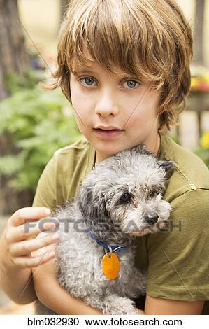 Caucasian boy holding puppy View Large Photo Image Stock Image - Caucasian boy holding puppy. Fotosearch