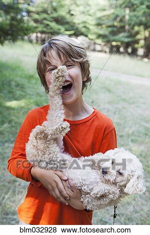 Caucasian boy playing with puppy outdoors View Large Photo Image Stock Photo - Caucasian boy playing with puppy outdoors. Fotosearch