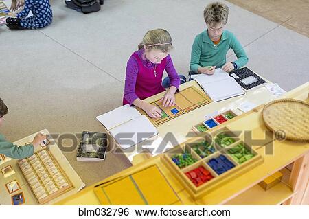 Caucasian children at table in classroom View Large Photo Image Stock Photograph - Caucasian children at table in classroom. Fotosearch