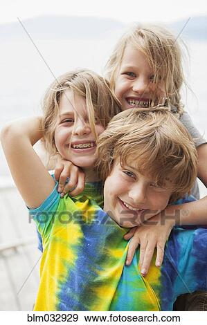 Caucasian children smiling together outdoors View Large Photo Image Stock Photo - Caucasian children smiling together outdoors. Fotosearch