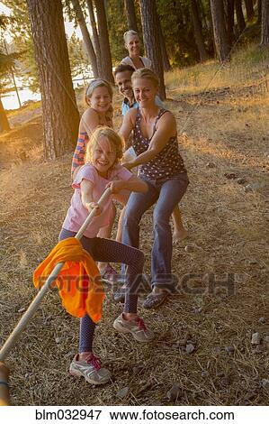 Caucasian family playing tug-of-war in forest View Large Photo Image Stock Photo - Caucasian family playing tug-of-war in forest. Fotosearch