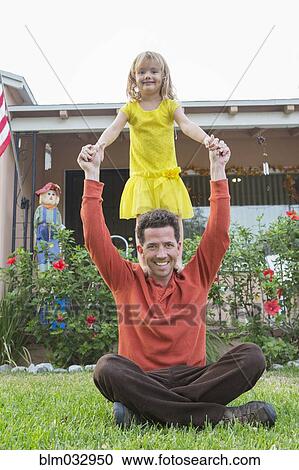 Caucasian father and daughter playing in backyard View Large Photo Image Stock Image - Caucasian father and daughter playing in backyard. Fotosearch