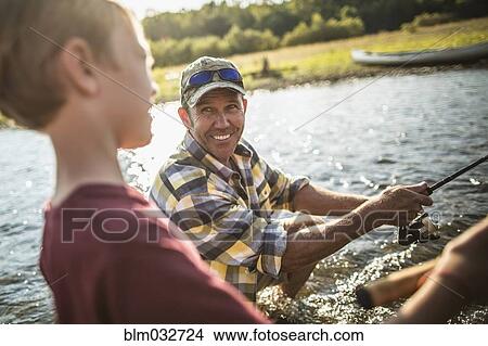 Caucasian father and son fishing in river View Large Photo Image Picture - Caucasian father and son fishing in river. Fotosearch
