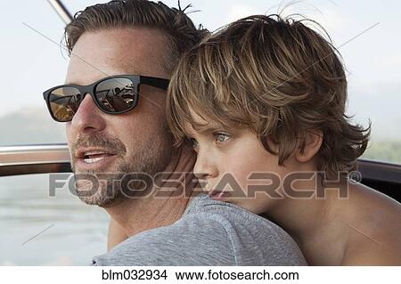 Caucasian father and son hugging outdoors View Large Photo Image Picture - Caucasian father and son hugging outdoors. Fotosearch