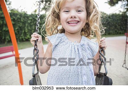 Caucasian girl playing on swing View Large Photo Image Stock Image - Caucasian girl playing on swing. Fotosearch