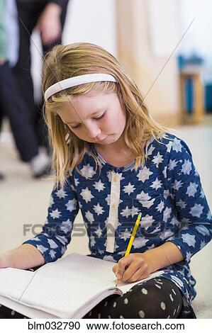 Caucasian girl writing in classroom View Large Photo Image Stock Image - Caucasian girl writing in classroom. Fotosearch