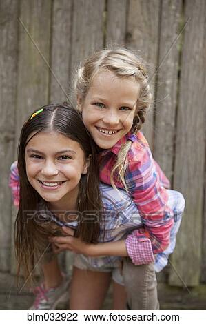 Stock Image - Caucasian girls playing outdoors. Fotosearch
