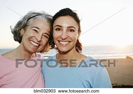 Caucasian mother and daughter hugging at beach View Large Photo Image Stock Image - Caucasian mother and daughter hugging at beach. Fotosearch