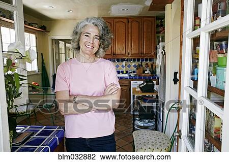 Caucasian woman smiling in kitchen View Large Photo Image Stock Image - Caucasian woman smiling in kitchen. Fotosearch