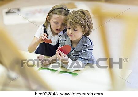 Children working together in classroom View Large Photo Image Stock Photo - Children working together in classroom. Fotosearch