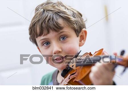 Close up of boy holding violin View Large Photo Image Stock Image - Close up of boy holding violin. Fotosearch