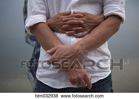 Close up of Caucasian couple hugging View Large Photo Image Stock Photo - Close up of Caucasian couple hugging. Fotosearch