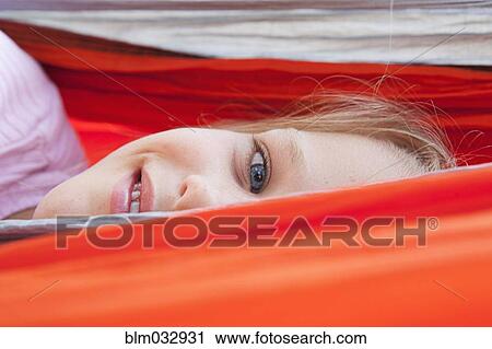 Close up of Caucasian girl peeking over hammock View Large Photo Image Stock Image - Close up of Caucasian girl peeking over hammock. Fotosearch