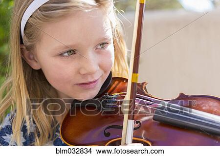 Picture - Close up of Caucasian girl playing violin. Fotosearch